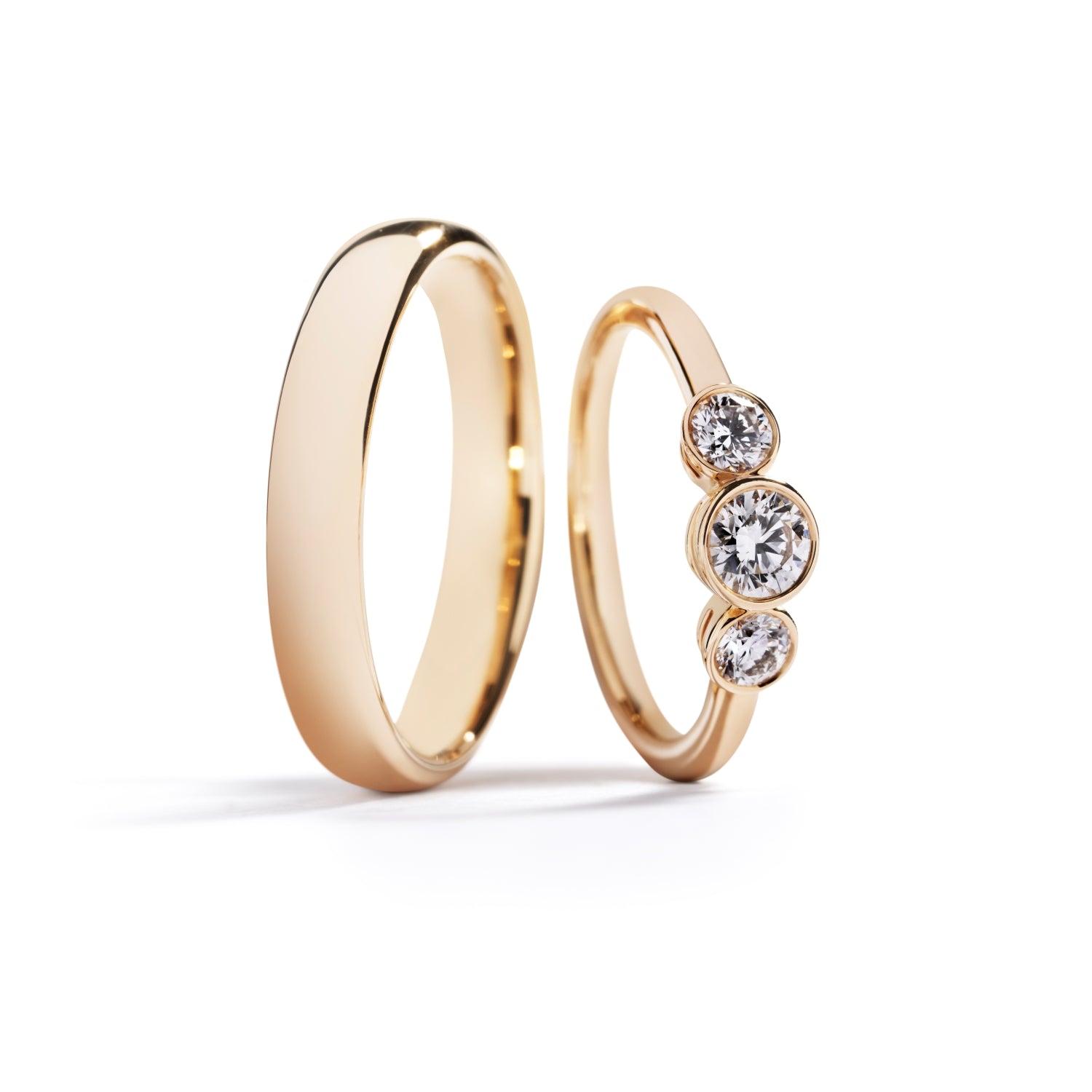 Damering i 18 kt. gulguld prydet med en 0,31ct. Top Wesselton(F)/VS2 brillant flankeret af to Top Wesselton/VVS-VS brillanter, i alt 0,30 ct. GIA certifikat medfølger. Kr. 23.900,- Herrering i 18 kt. gulguld 4 mm. Kr. 12.500,-
